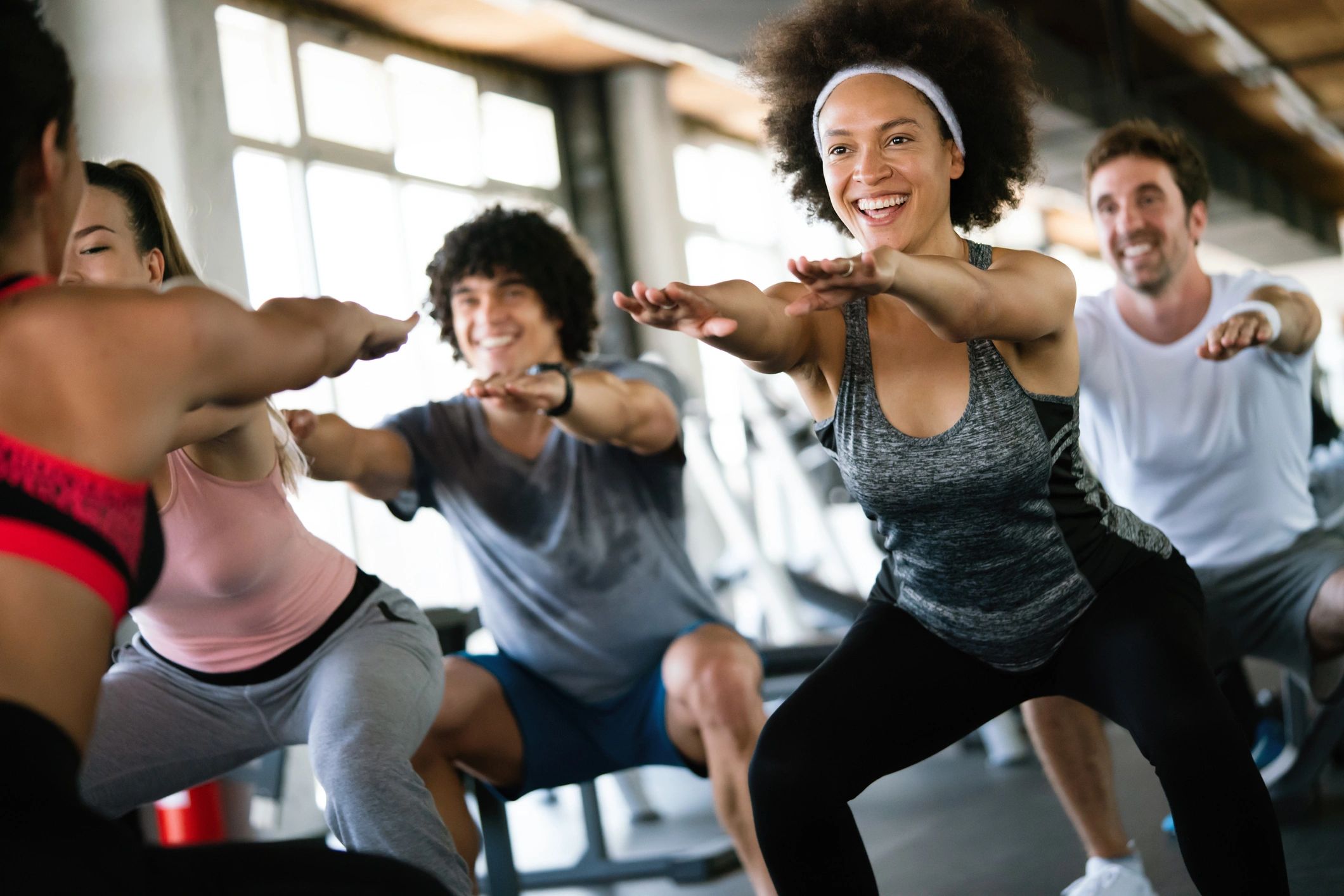 Group of happy fit people at the gym