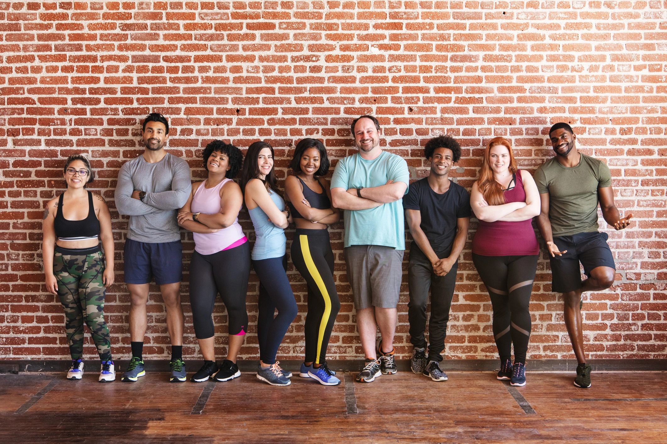 Diverse group of people in sportswear stand at